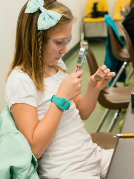 Girl with magnifying glass