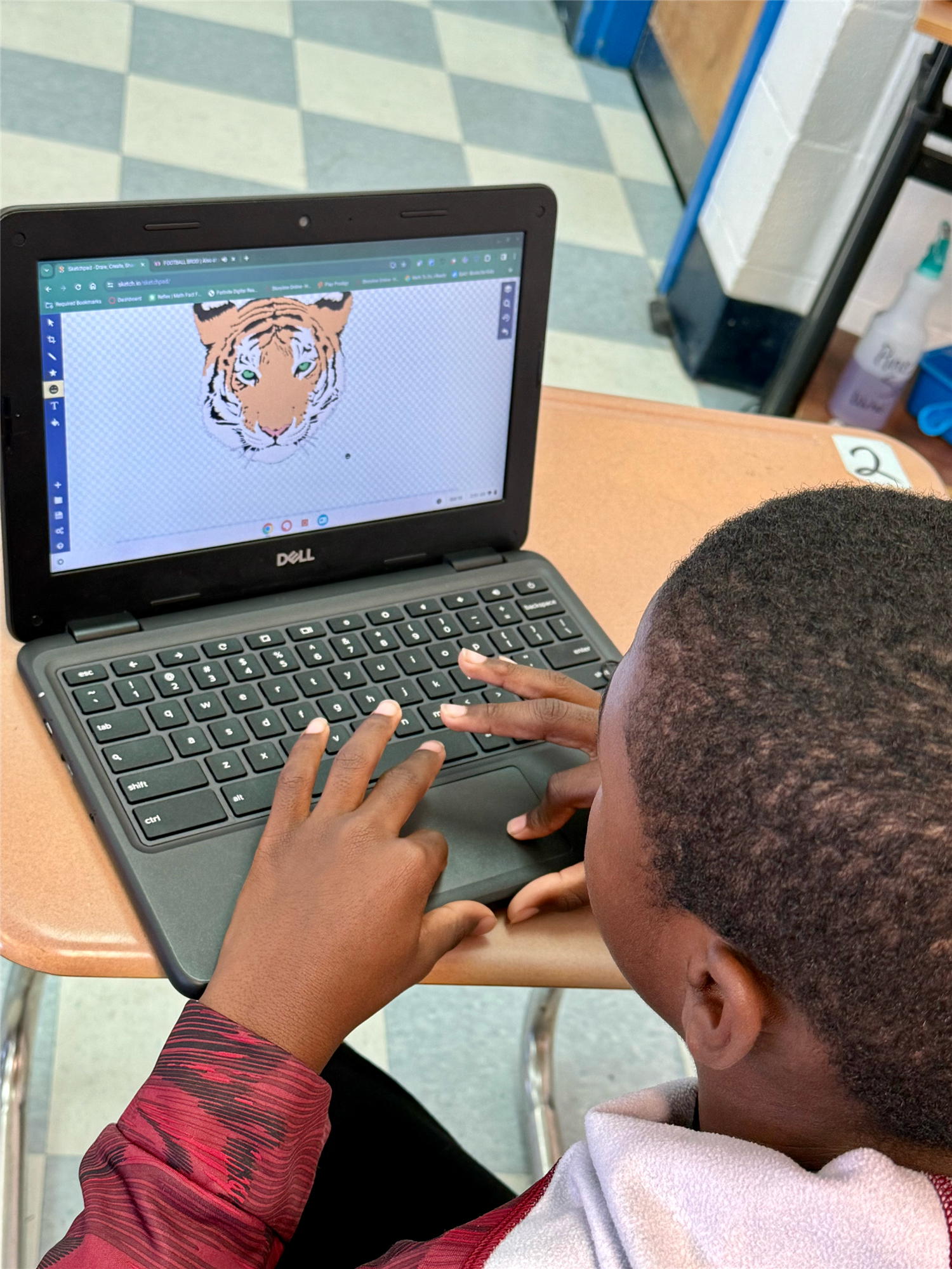 A student in the Digital Arts program works on a tiger design.